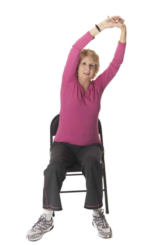 Mature woman stretching cancer exercise training institute