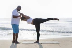 couple exercising on beach cancer exercise training institute